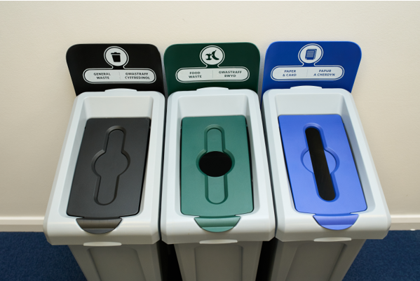 Three color-coded recycling bins for general waste