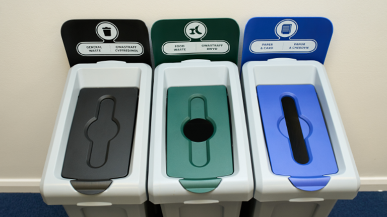 Three color-coded recycling bins for general waste