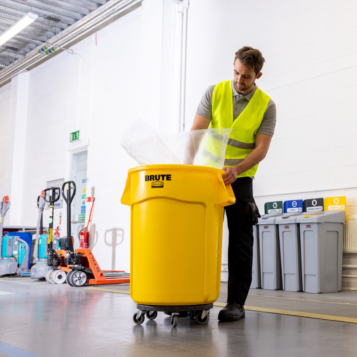 Yellow BRUTE® container on a warehouse floor